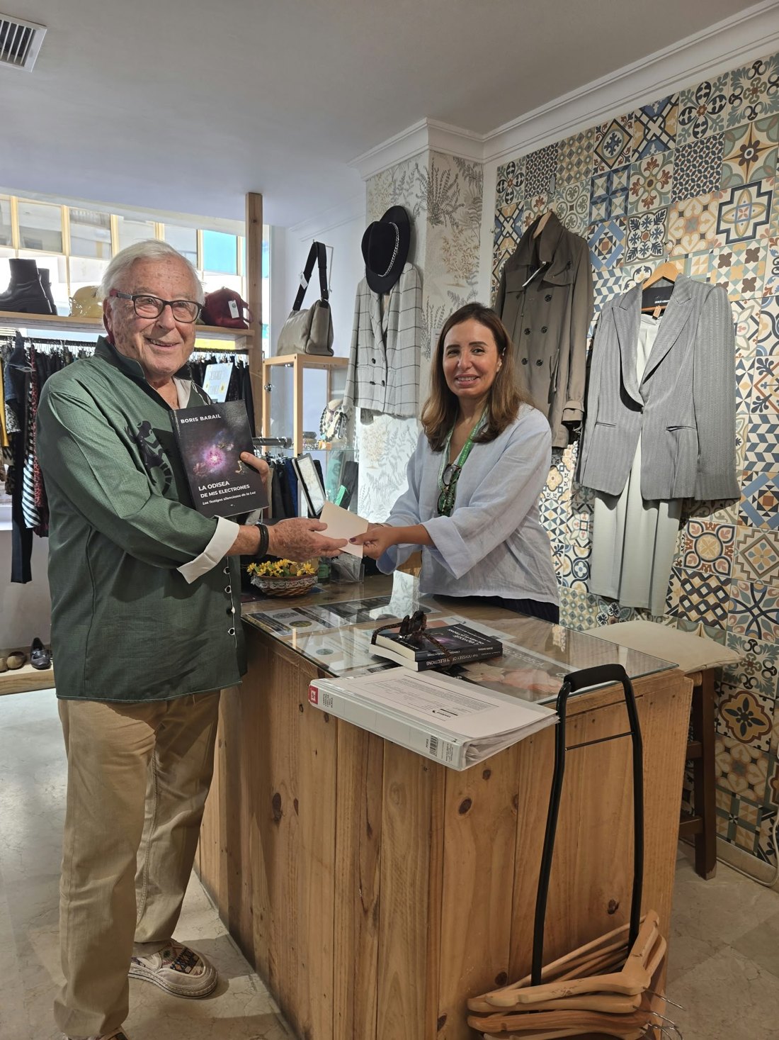 Boris Barail hands the donation to a CUDECA team member